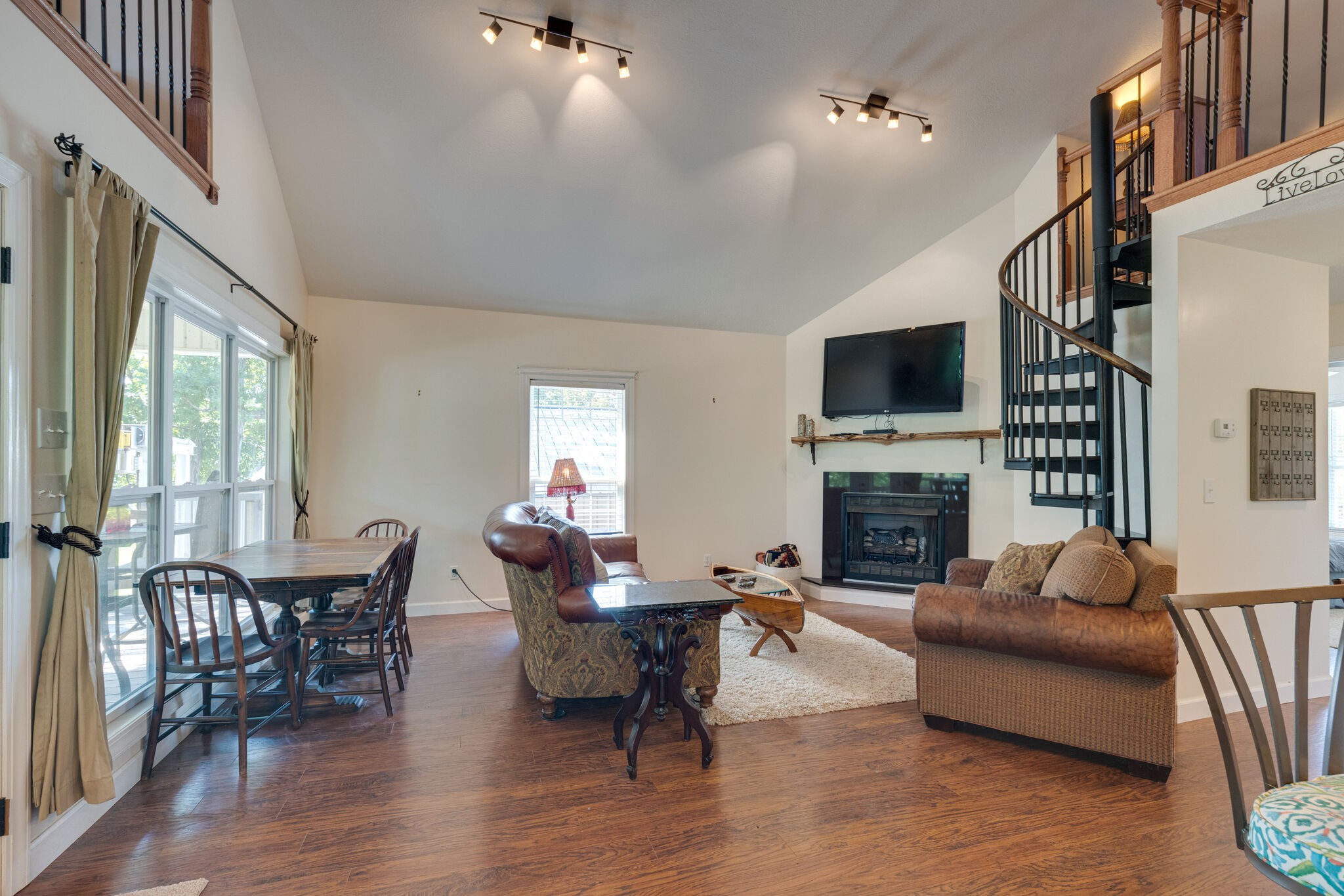 752 Pevahouse Camp Lane Decaturville, TN 38329 - Photo 11 of 47 a living room with furniture a fireplace and a flat screen tv