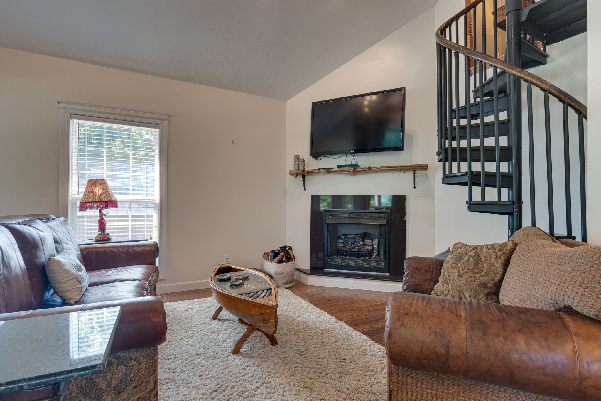 752 Pevahouse Camp Lane Decaturville, TN 38329 - Photo 12 of 47 a living room with furniture a flat screen tv and a fireplace