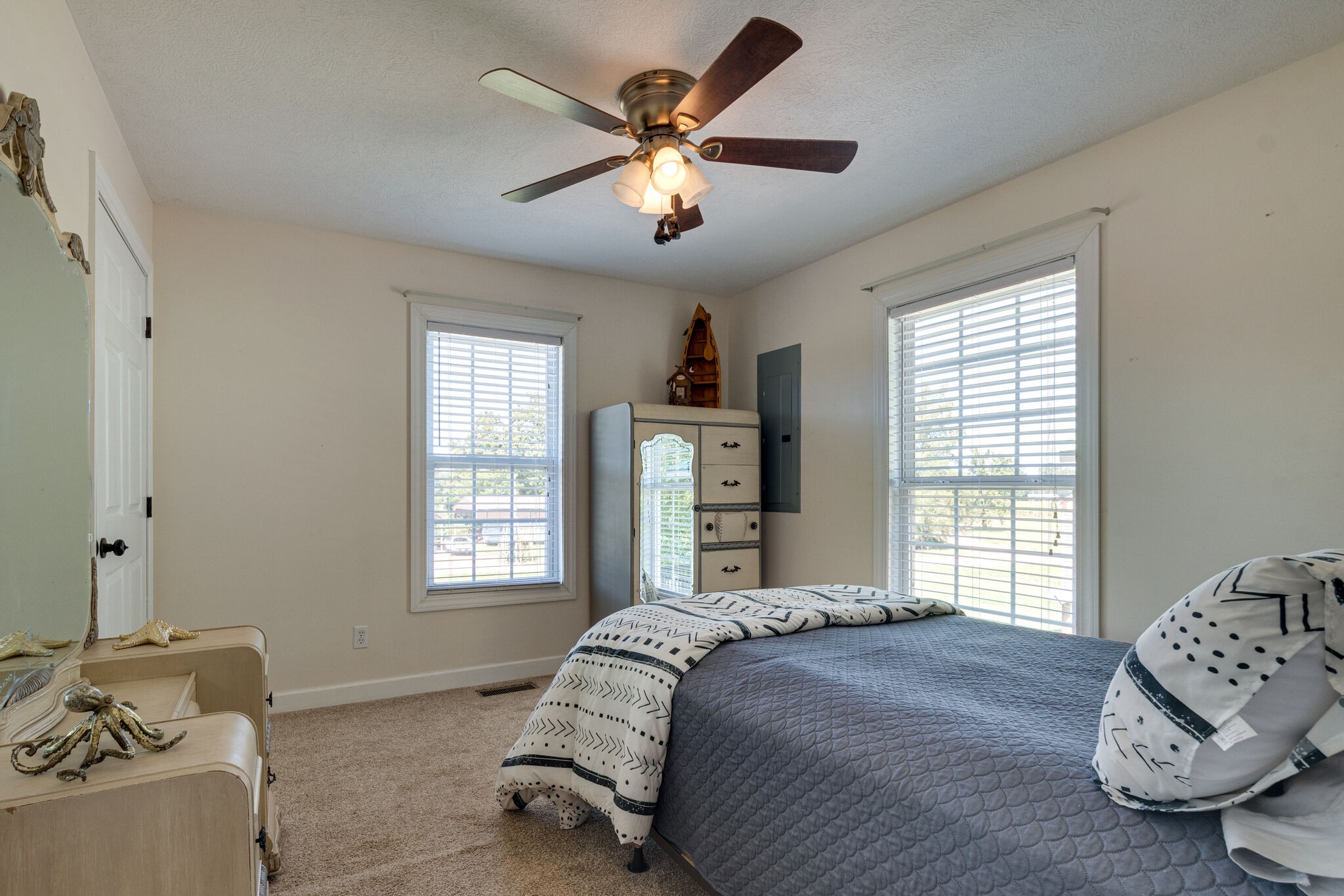 752 Pevahouse Camp Lane Decaturville, TN 38329 - Photo 16 of 47 a bedroom with a bed and a chandelier