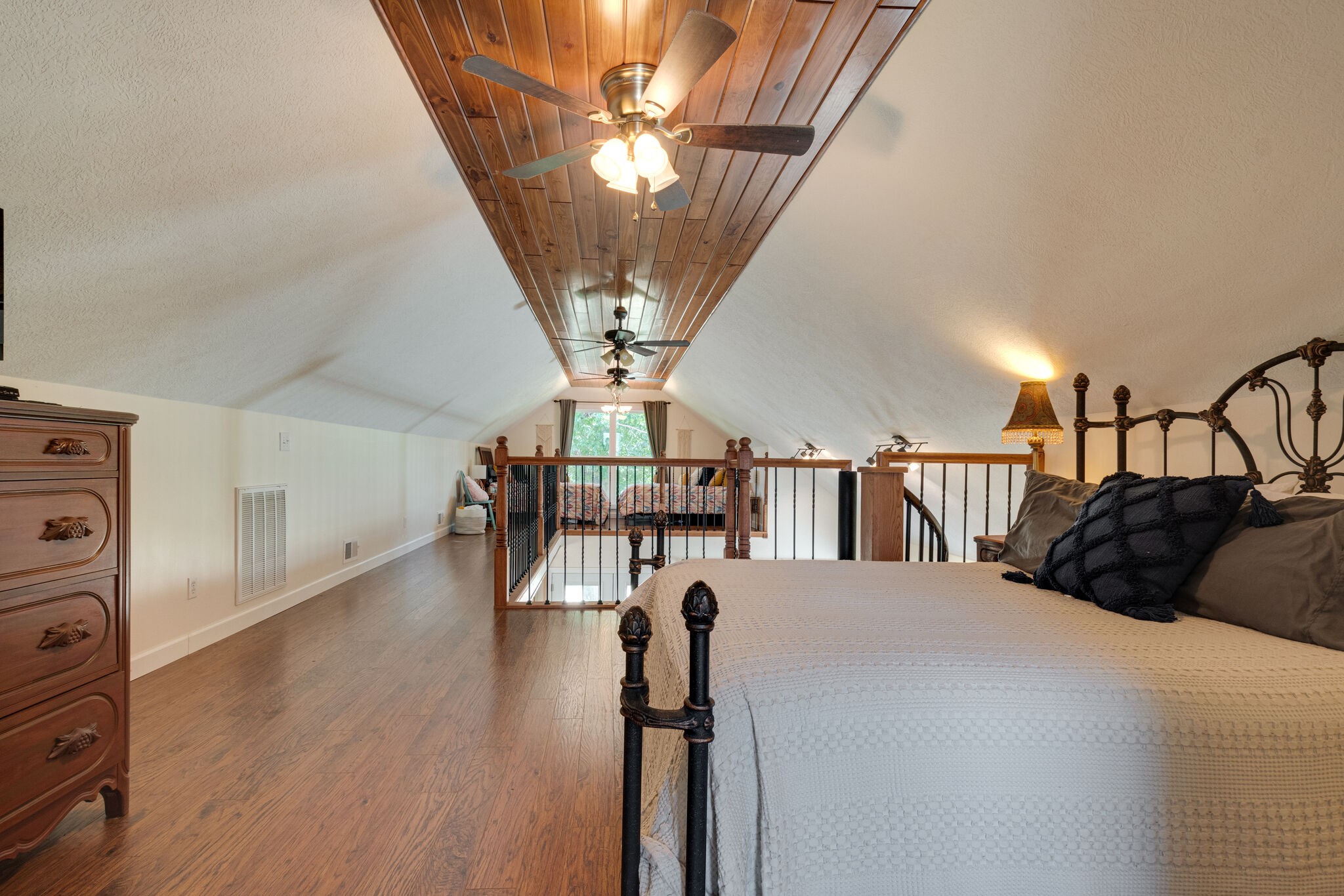 752 Pevahouse Camp Lane Decaturville, TN 38329 - Photo 25 of 47 a bedroom with a bed a chandelier and flat screen tv