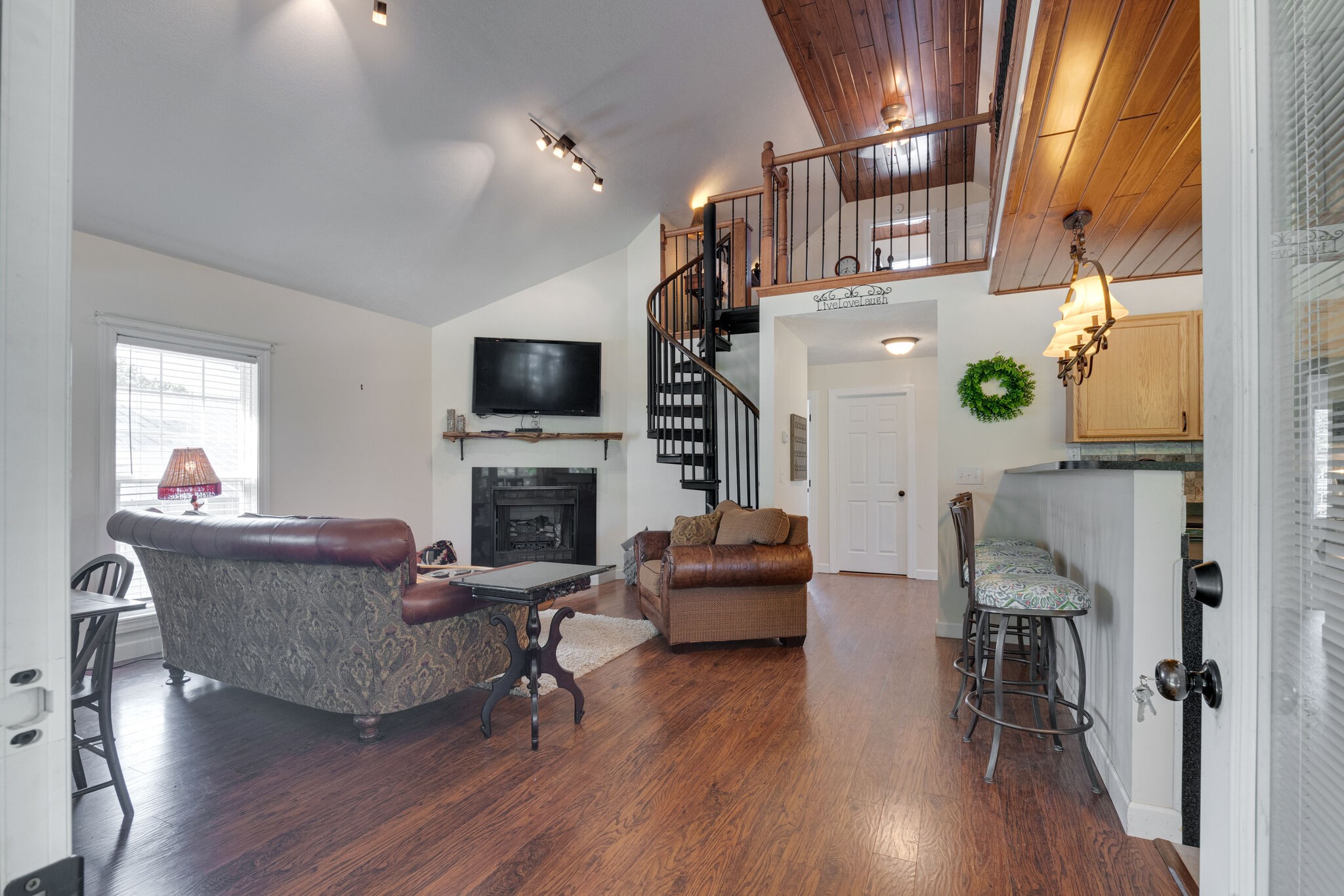 752 Pevahouse Camp Lane Decaturville, TN 38329 - Photo 9 of 47 a living room with furniture a fireplace and a flat screen tv