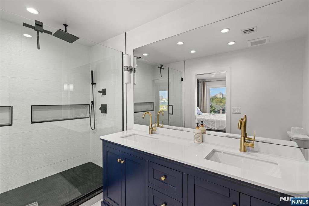 7 Oakdene Terrace, Unit 7 Edgewater, NJ 07020 - Photo 20 of 30 a bathroom with a double vanity sink mirror and double