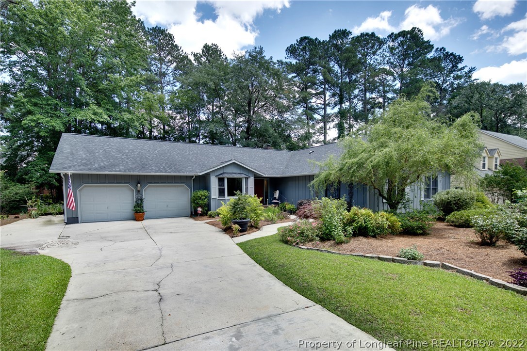 2927 Middlesex Road Fayetteville, NC 28306 - Photo 3 of 50 a front view of a house with a yard and potted plants