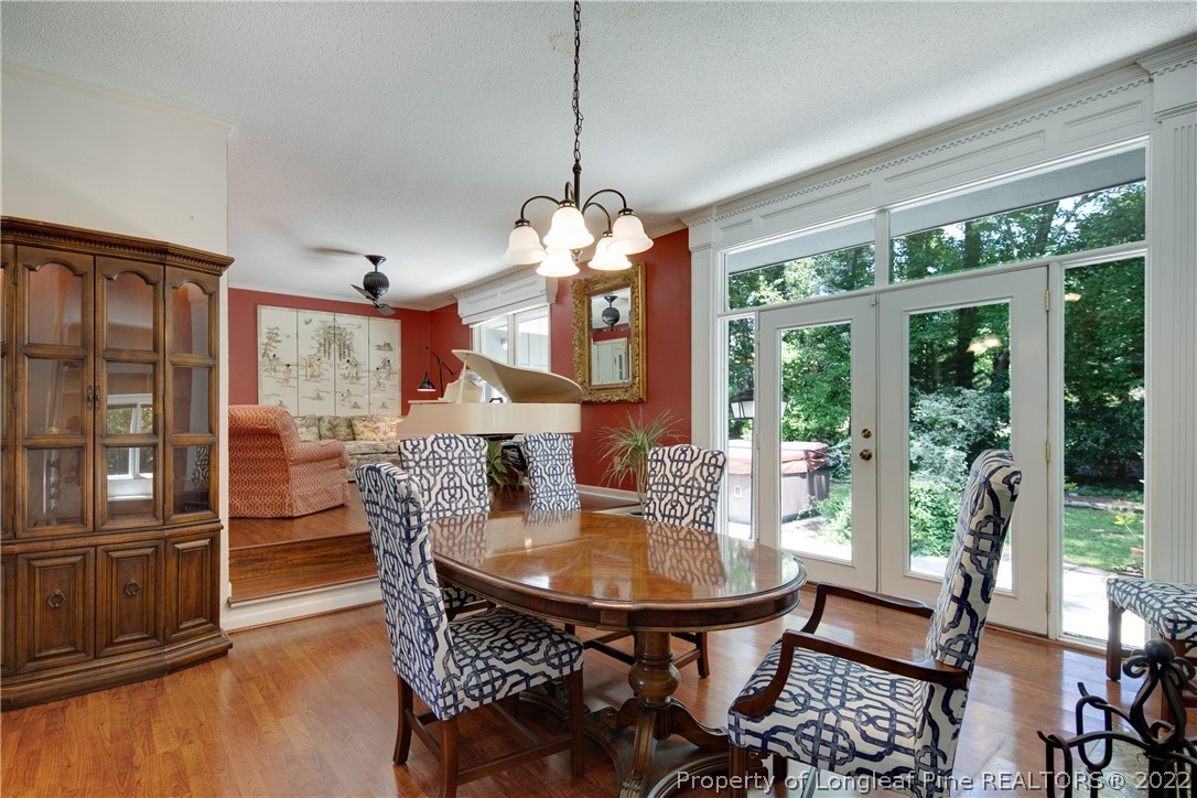 2927 Middlesex Road Fayetteville, NC 28306 - Photo 9 of 50 a dining room with furniture a chandelier and wooden floor