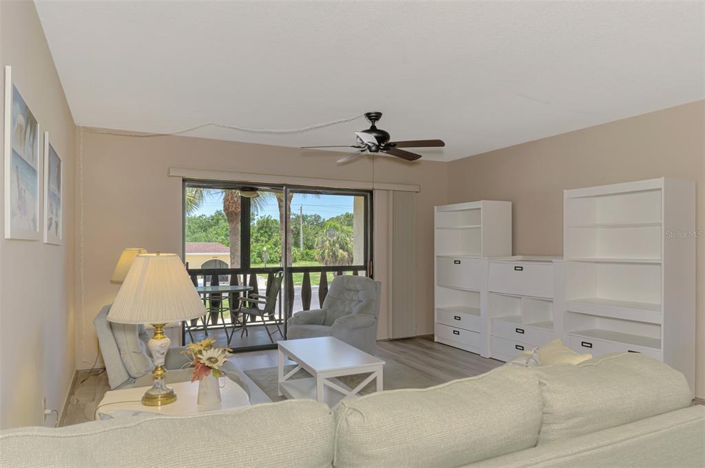 96 Boundary Boulevard, Unit 127 Rotonda West, FL 33947 - Photo 11 of 47 a living room with furniture and a large window