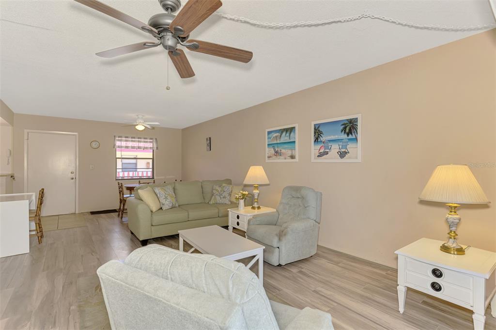 96 Boundary Boulevard, Unit 127 Rotonda West, FL 33947 - Photo 12 of 47 a living room with furniture and a wooden floor