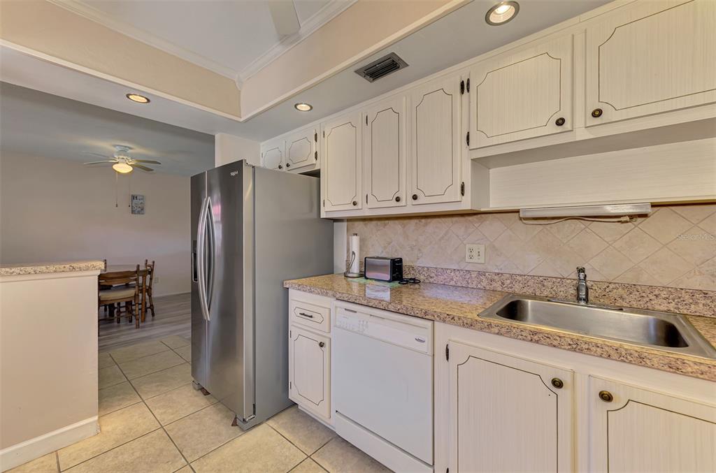 96 Boundary Boulevard, Unit 127 Rotonda West, FL 33947 - Photo 16 of 47 a kitchen with a sink and refrigerator