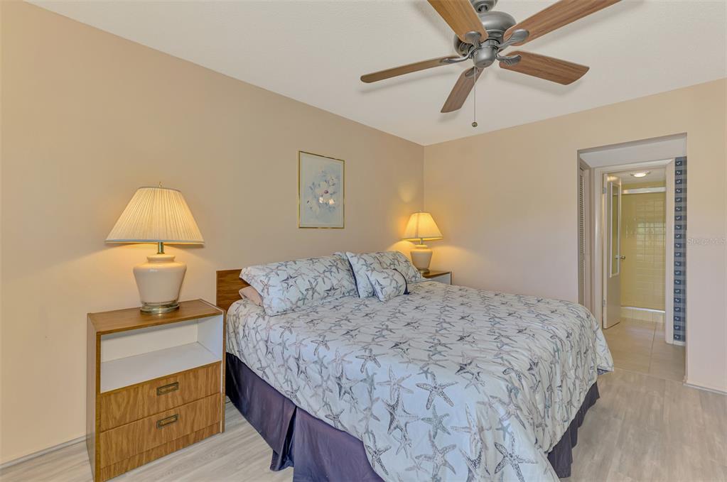 96 Boundary Boulevard, Unit 127 Rotonda West, FL 33947 - Photo 18 of 47 a bedroom with a bed and a chandelier