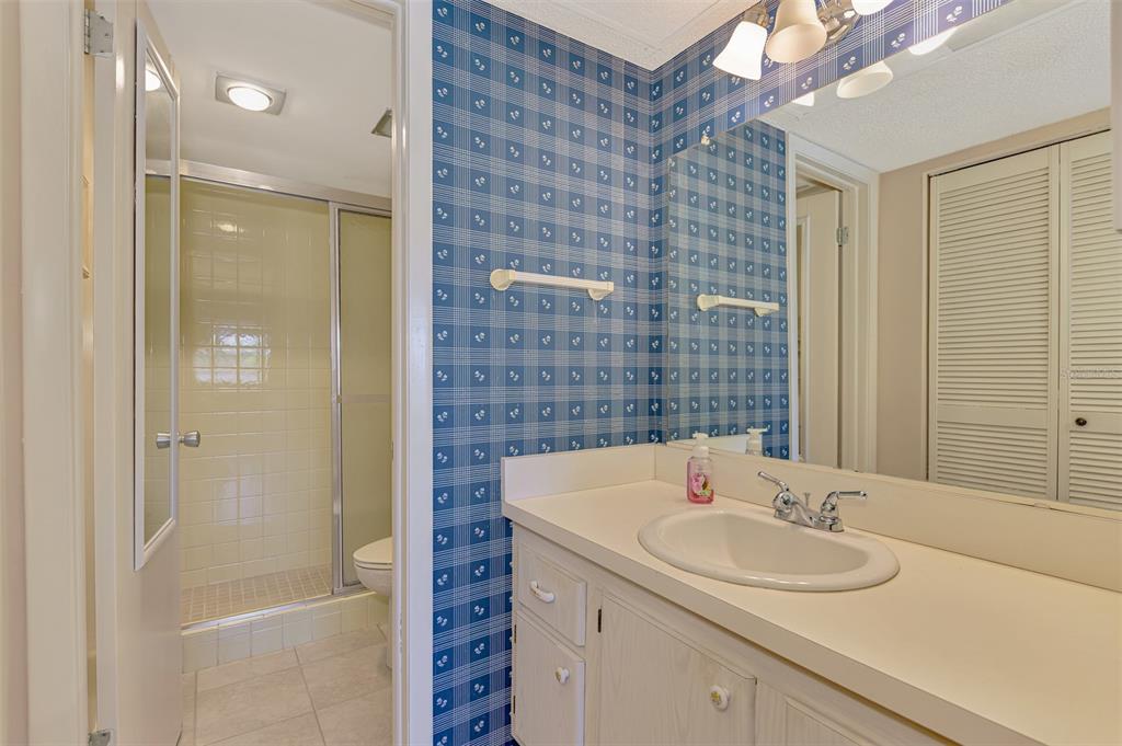 96 Boundary Boulevard, Unit 127 Rotonda West, FL 33947 - Photo 19 of 47 a bathroom with a sink and a mirror