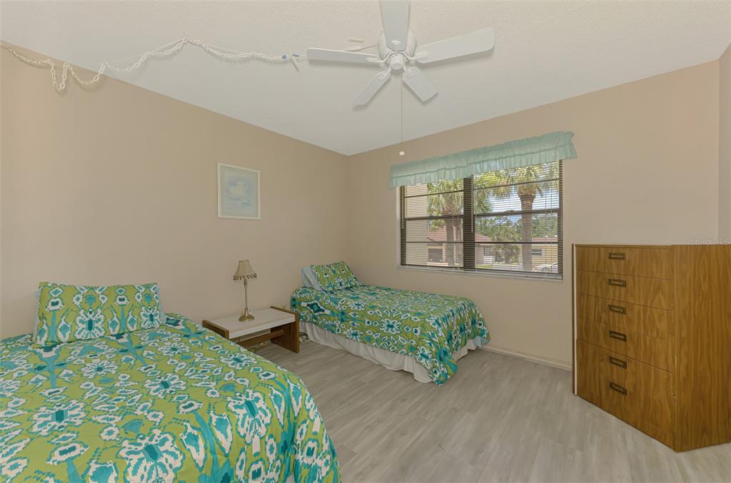 96 Boundary Boulevard, Unit 127 Rotonda West, FL 33947 - Photo 22 of 47 a bedroom with a bed and a dresser