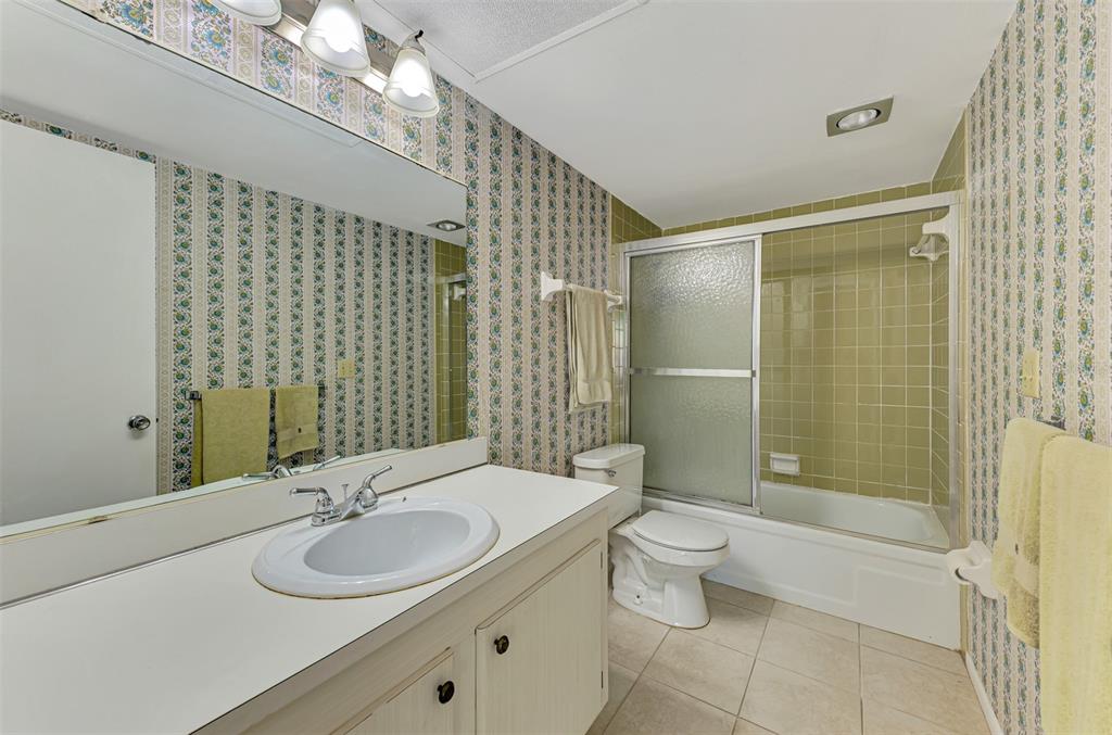96 Boundary Boulevard, Unit 127 Rotonda West, FL 33947 - Photo 23 of 47 a bathroom with a sink toilet and shower