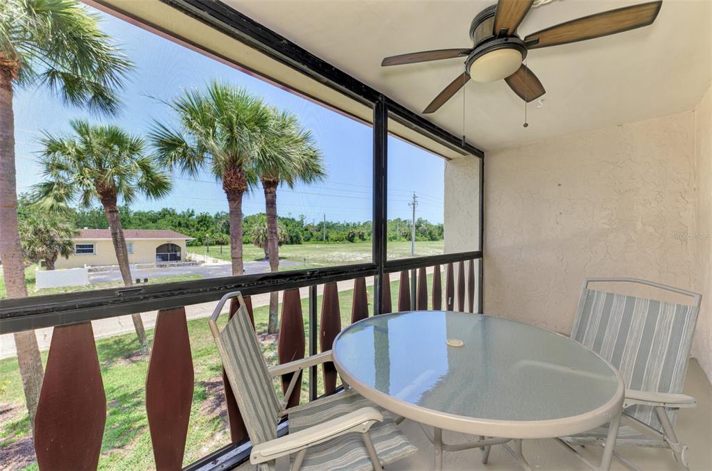 96 Boundary Boulevard, Unit 127 Rotonda West, FL 33947 - Photo 27 of 47 a view of a chairs and table in patio