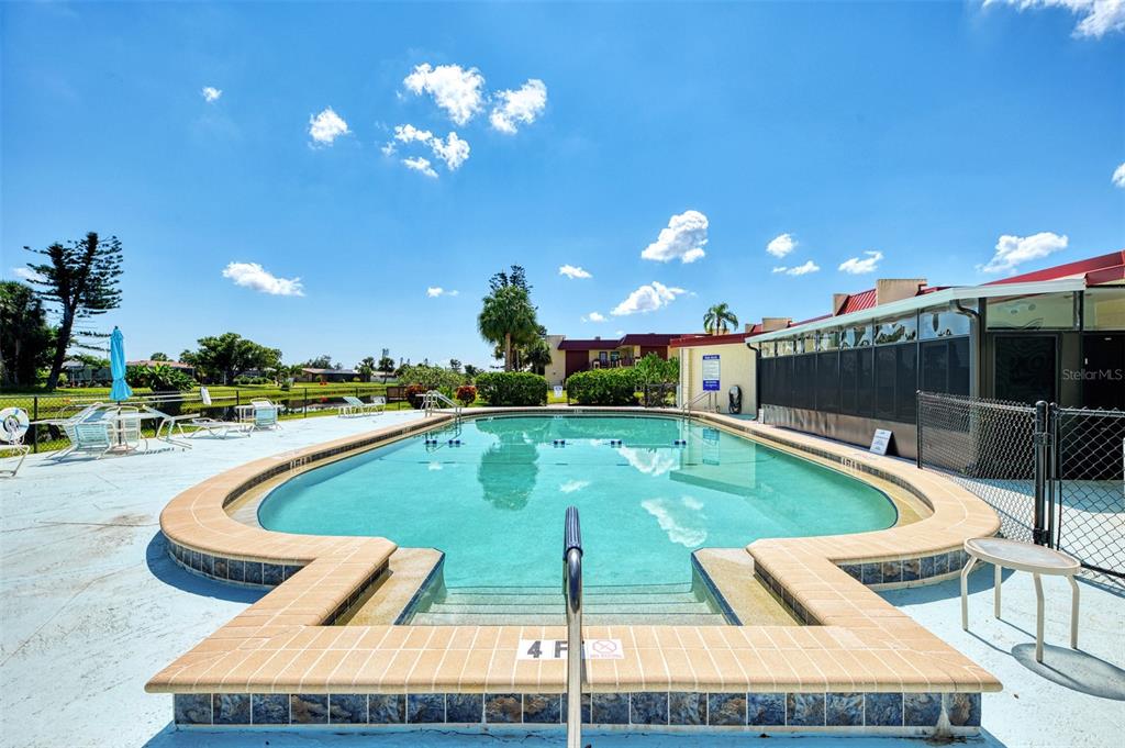 96 Boundary Boulevard, Unit 127 Rotonda West, FL 33947 - Photo 29 of 47 a view of a swimming pool with a patio and a dining space