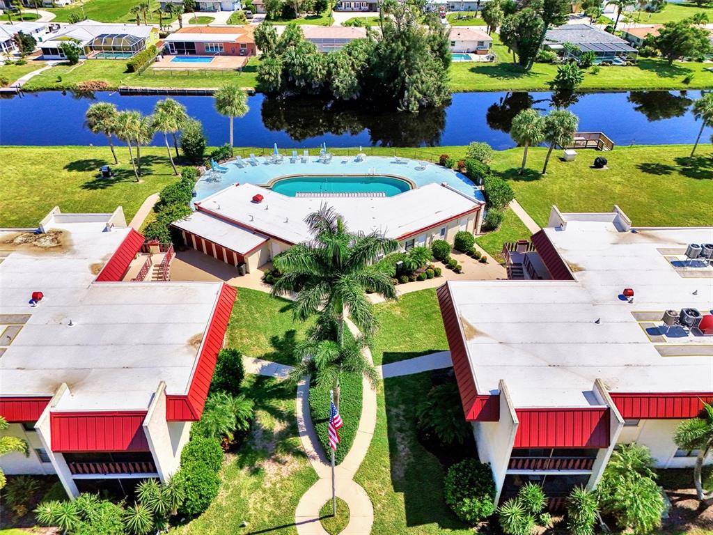 96 Boundary Boulevard, Unit 127 Rotonda West, FL 33947 - Photo 39 of 47 an aerial view of swimming pool patio and outdoor seating