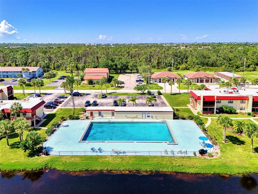 96 Boundary Boulevard, Unit 127 Rotonda West, FL 33947 - Photo 42 of 47 a view of swimming pool with outdoor seating and yard