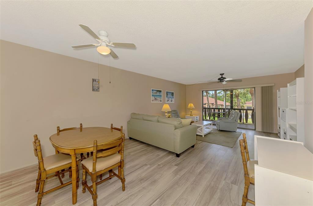 96 Boundary Boulevard, Unit 127 Rotonda West, FL 33947 - Photo 7 of 47 a living room with furniture and a large window