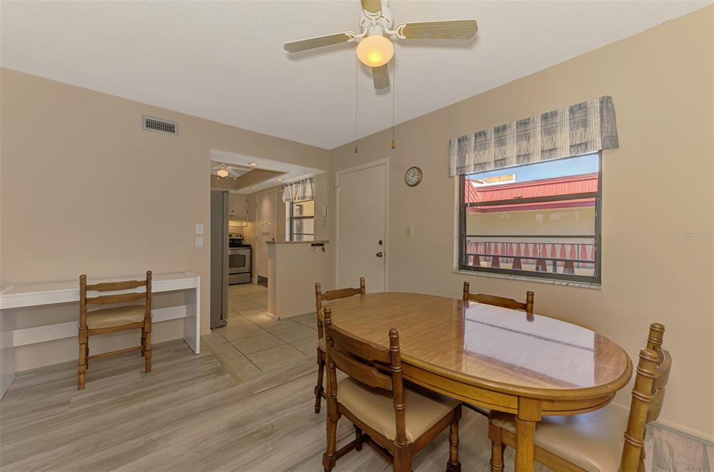 96 Boundary Boulevard, Unit 127 Rotonda West, FL 33947 - Photo 8 of 47 a view of a dining room with furniture and wooden floor