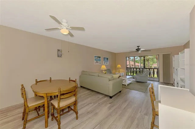a room with stainless steel appliances kitchen island a chandelier