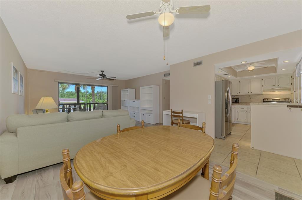 96 Boundary Boulevard, Unit 127 Rotonda West, FL 33947 - Photo 9 of 47 a room with kitchen island a chandelier and fireplace