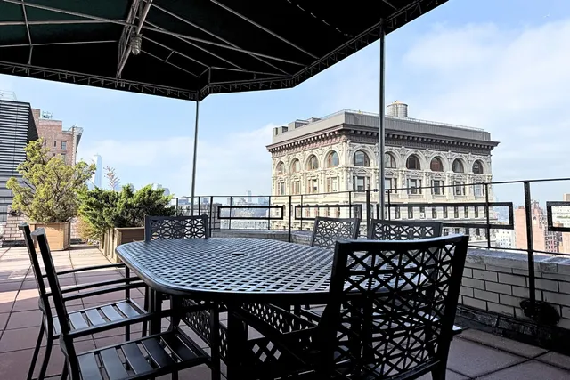 a view of a chairs and table in patio