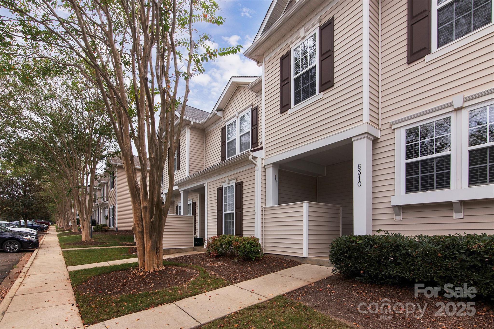 6310 Rhodins Lane Fort Mill, SC 29707 - Photo 2 of 22 a front view of a house with garden