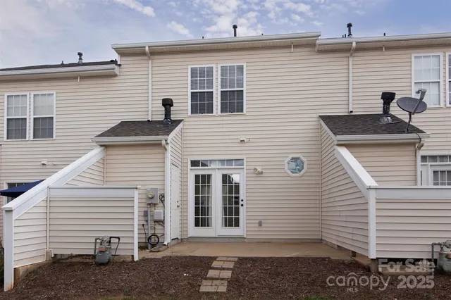 a view of a white house with many windows