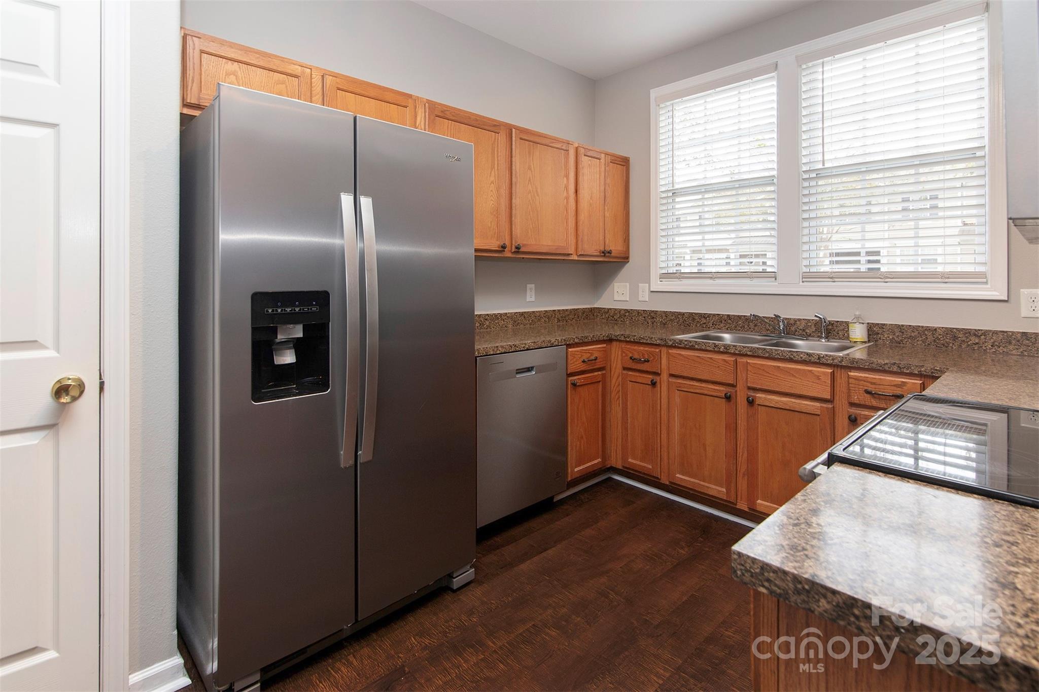 6310 Rhodins Lane Fort Mill, SC 29707 - Photo 6 of 22 a kitchen with stainless steel appliances granite countertop a sink stove and refrigerator