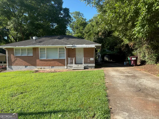 a front view of house with yard and green space