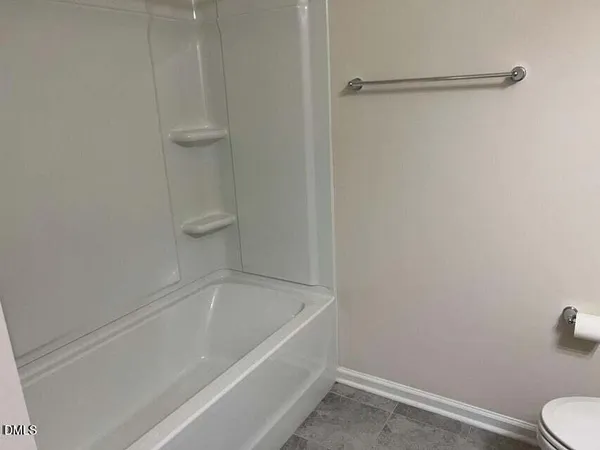 a bathroom with a bathtub and toilet