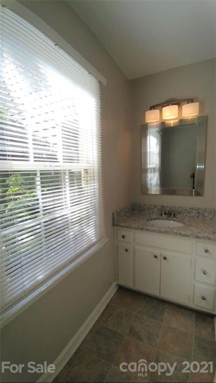 6517 Park Road Charlotte, NC 28210 - Photo 11 of 20 a bathroom with a sink and a large mirror next to a window