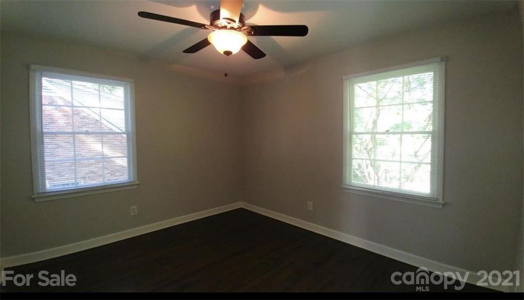 6517 Park Road Charlotte, NC 28210 - Photo 15 of 20 a view of an empty room with wooden floor and a window