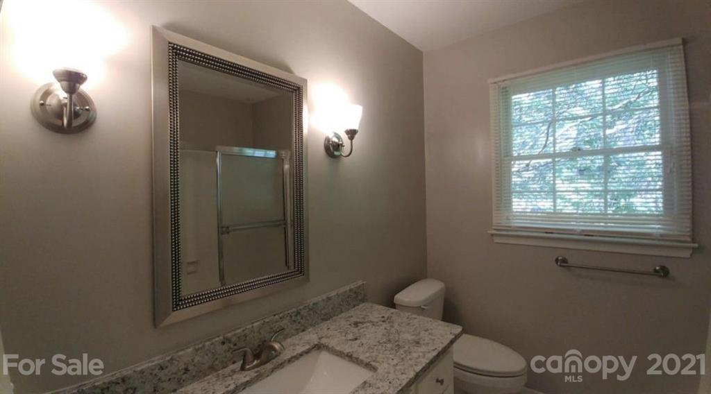 6517 Park Road Charlotte, NC 28210 - Photo 17 of 20 a bathroom with a toilet and a window