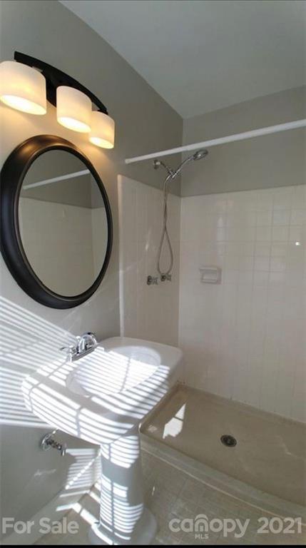 6517 Park Road Charlotte, NC 28210 - Photo 20 of 20 a bathroom with a granite countertop sink a mirror and shower