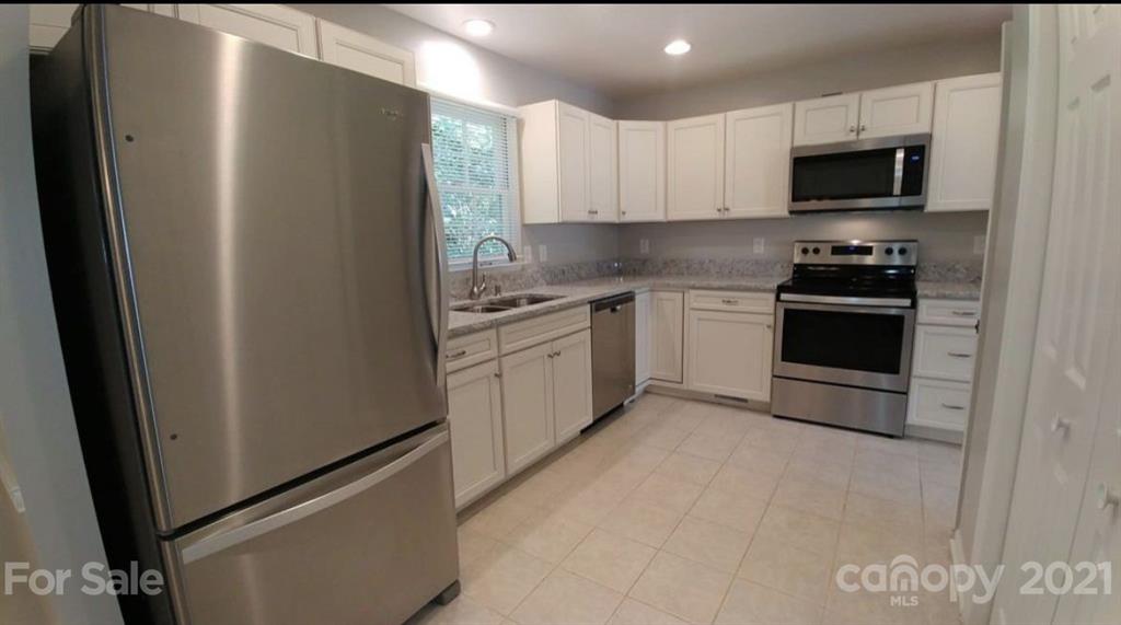 6517 Park Road Charlotte, NC 28210 - Photo 3 of 20 a kitchen with stainless steel appliances a refrigerator sink and microwave