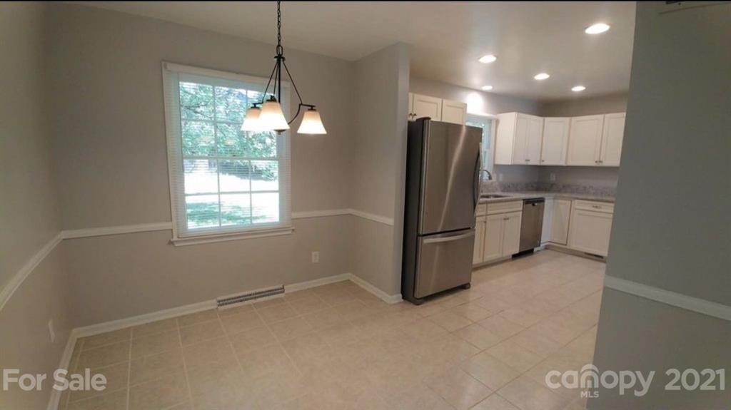 6517 Park Road Charlotte, NC 28210 - Photo 5 of 20 a kitchen with stainless steel appliances a refrigerator sink and stove