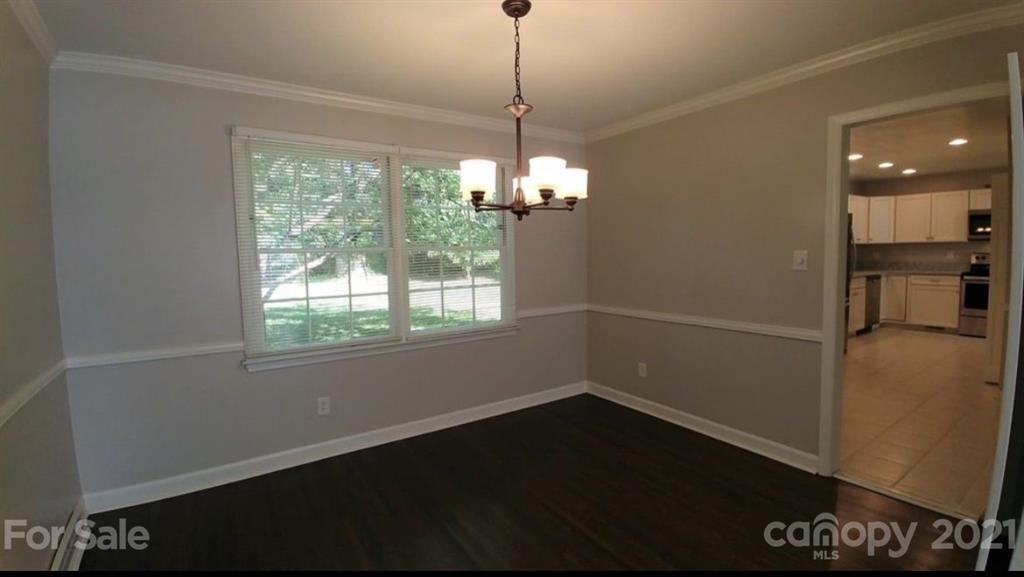 6517 Park Road Charlotte, NC 28210 - Photo 6 of 20 a room with wooden floor and windows
