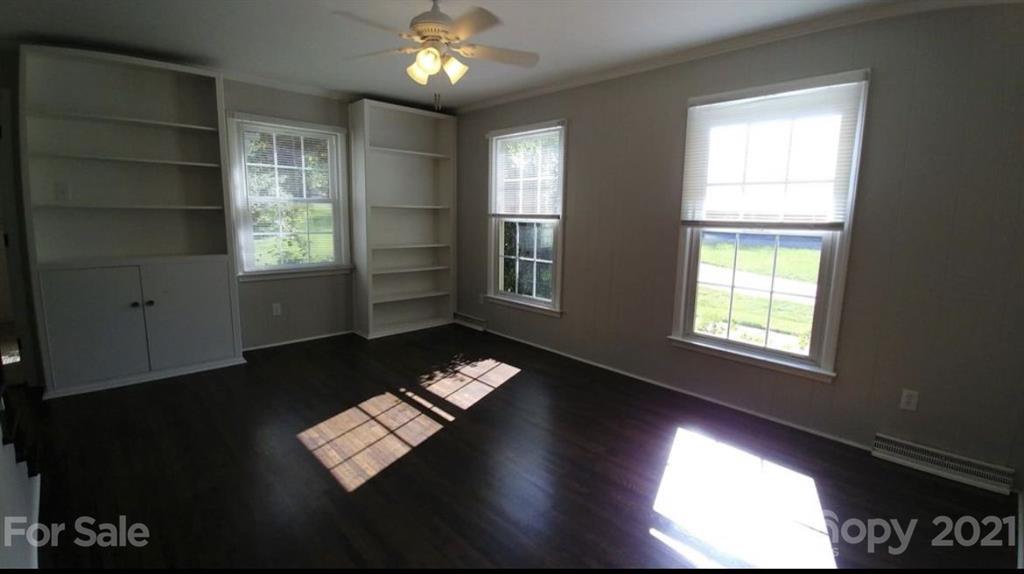 6517 Park Road Charlotte, NC 28210 - Photo 9 of 20 a view of an empty room with a window and wooden floor