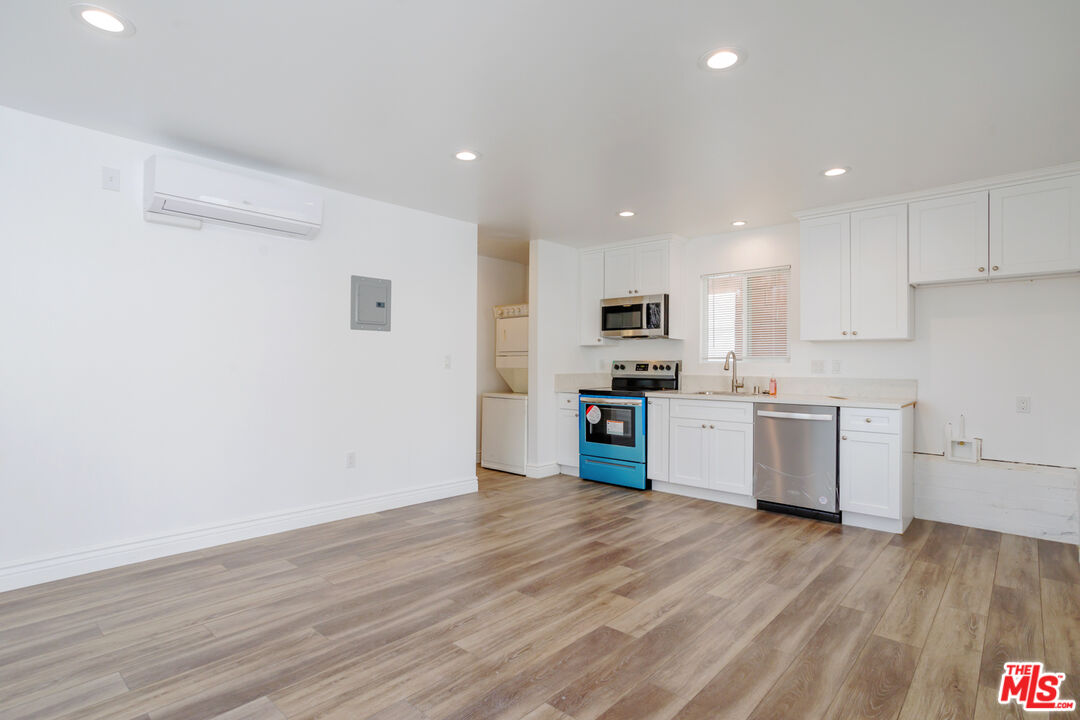 1789 1/2 Atchison Street Pasadena, CA 91104 - Photo 12 of 21 a kitchen with granite countertop a sink cabinets and stainless steel appliances