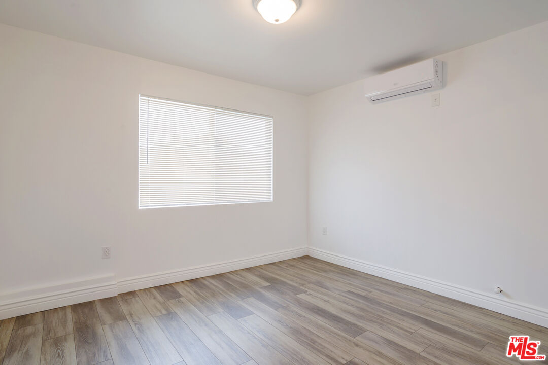 1789 1/2 Atchison Street Pasadena, CA 91104 - Photo 16 of 21 an empty room with wooden floor and windows
