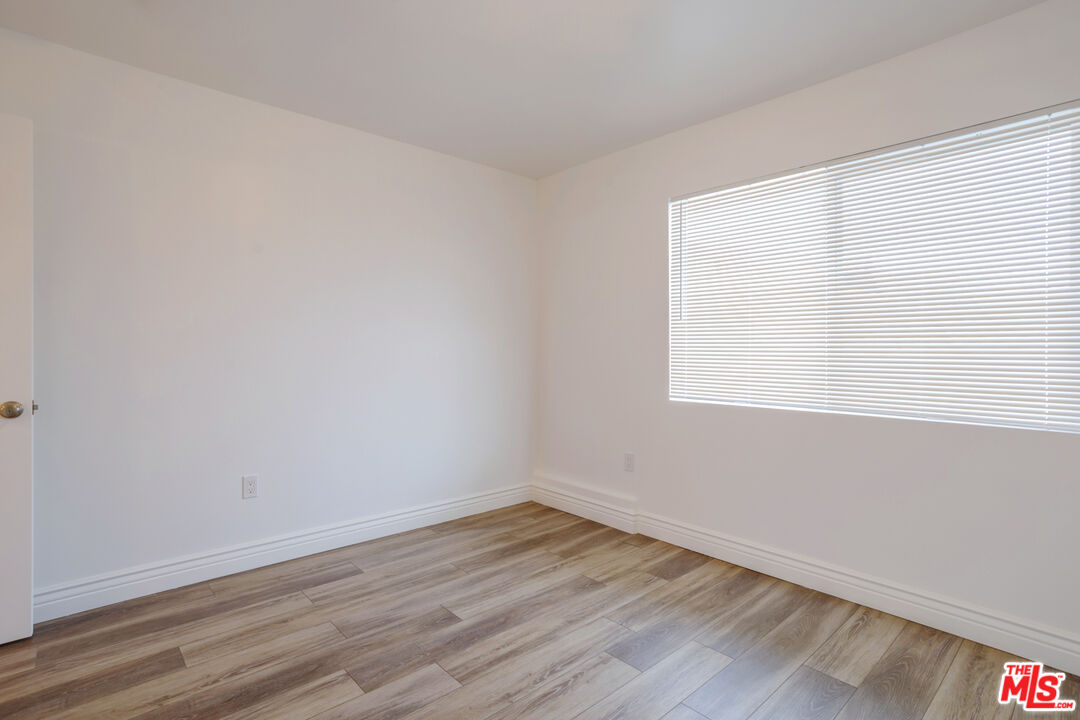 1789 1/2 Atchison Street Pasadena, CA 91104 - Photo 17 of 21 wooden floor in an empty room with a window