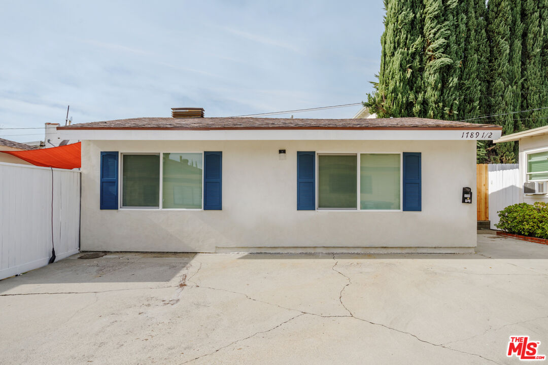 1789 1/2 Atchison Street Pasadena, CA 91104 - Photo 5 of 21 a front view of a house with a yard and a garage