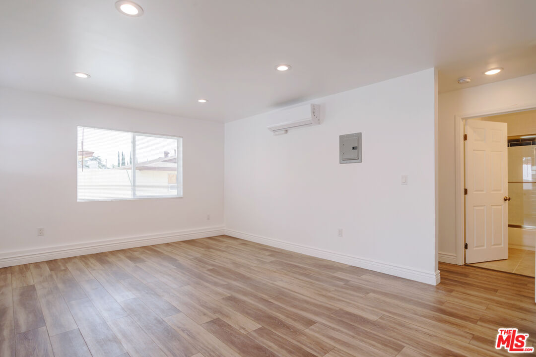 1789 1/2 Atchison Street Pasadena, CA 91104 - Photo 10 of 21 an empty room with wooden floor and windows