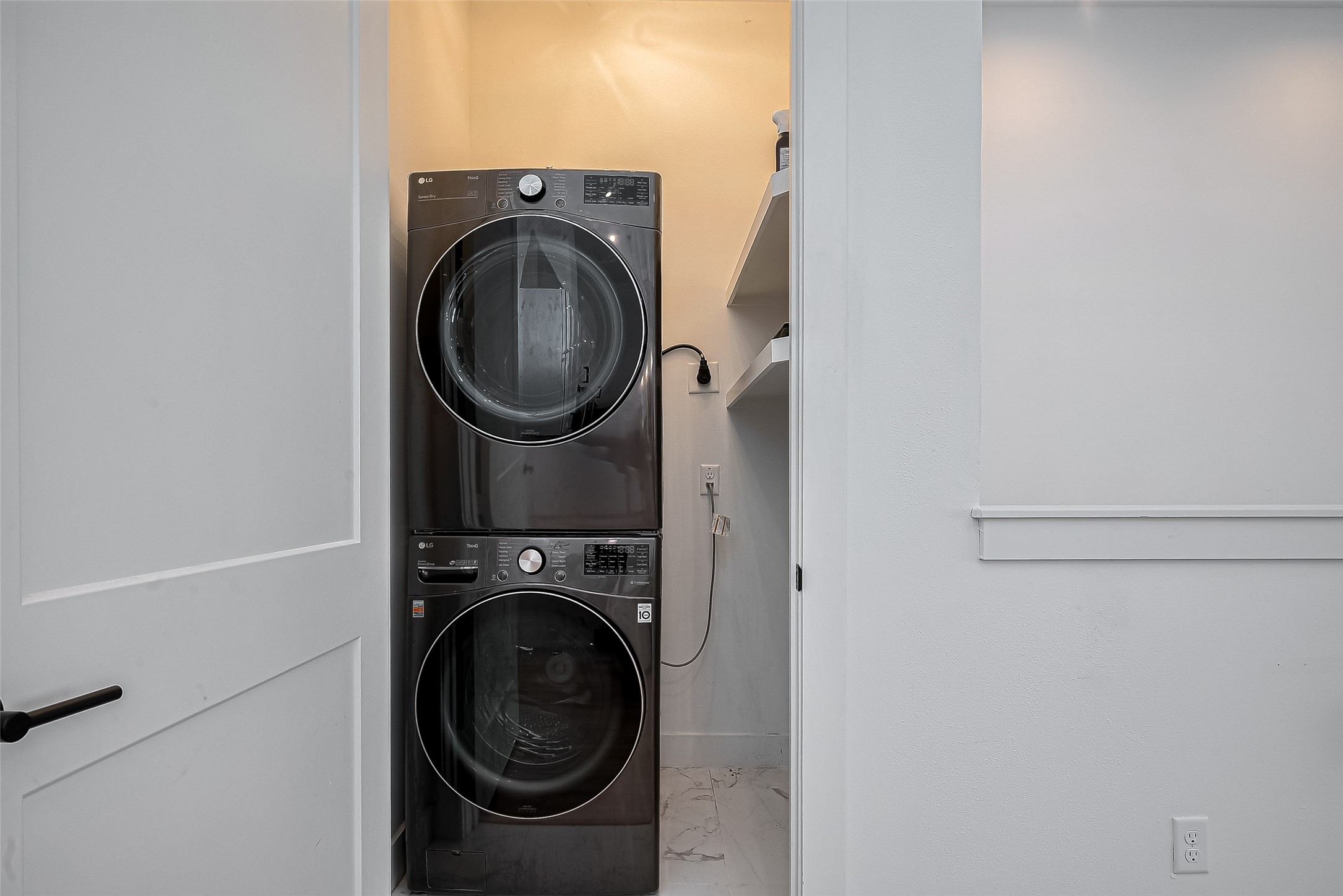 2518 Terry Street Houston, TX 77009 - Photo 6 of 17 Dedicated utility area with stacked front-load washer and dryer plus built-in storage shelving for added convenience.