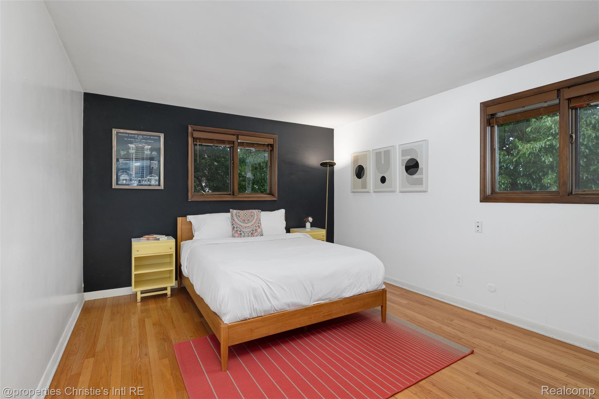2771 West Seven Mile Road Detroit, MI 48221 - Photo 37 of 57 Hardwood flooring throughout, complemented by a feature wall and white painted walls