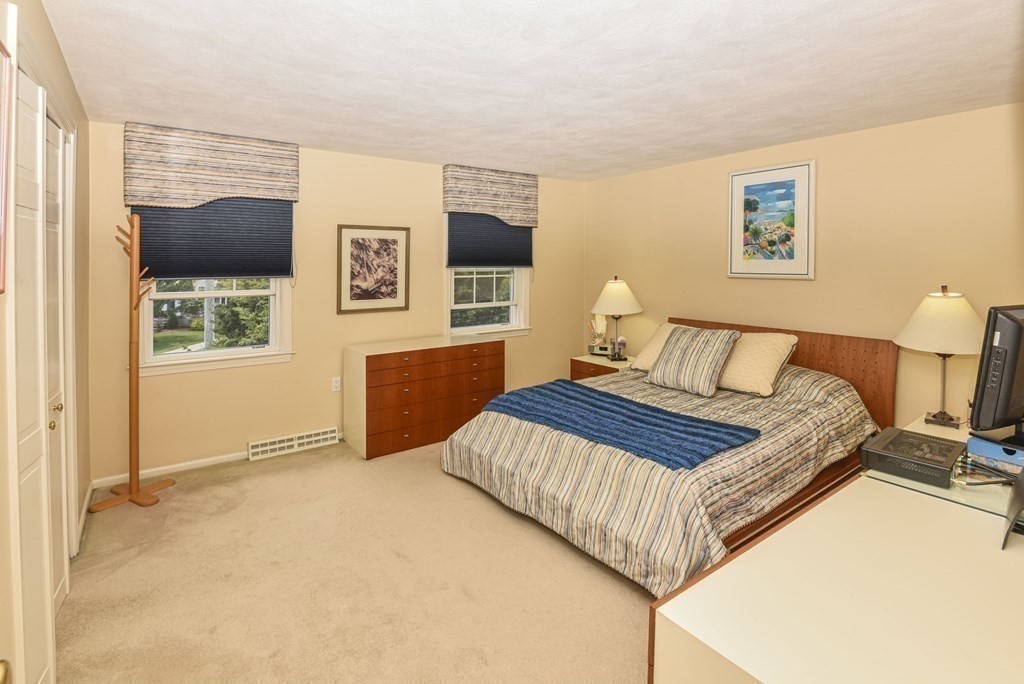 38 Clough Road, Unit 38 Dedham, MA 02026 - Photo 10 of 18 a bedroom with a bed and wooden floor