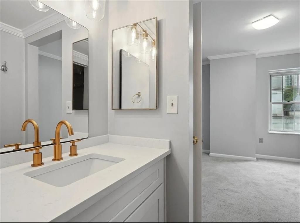 199 14th Street Northeast, Unit 210 Atlanta, GA 30309 - Photo 6 of 12 a bathroom with a sink and a mirror