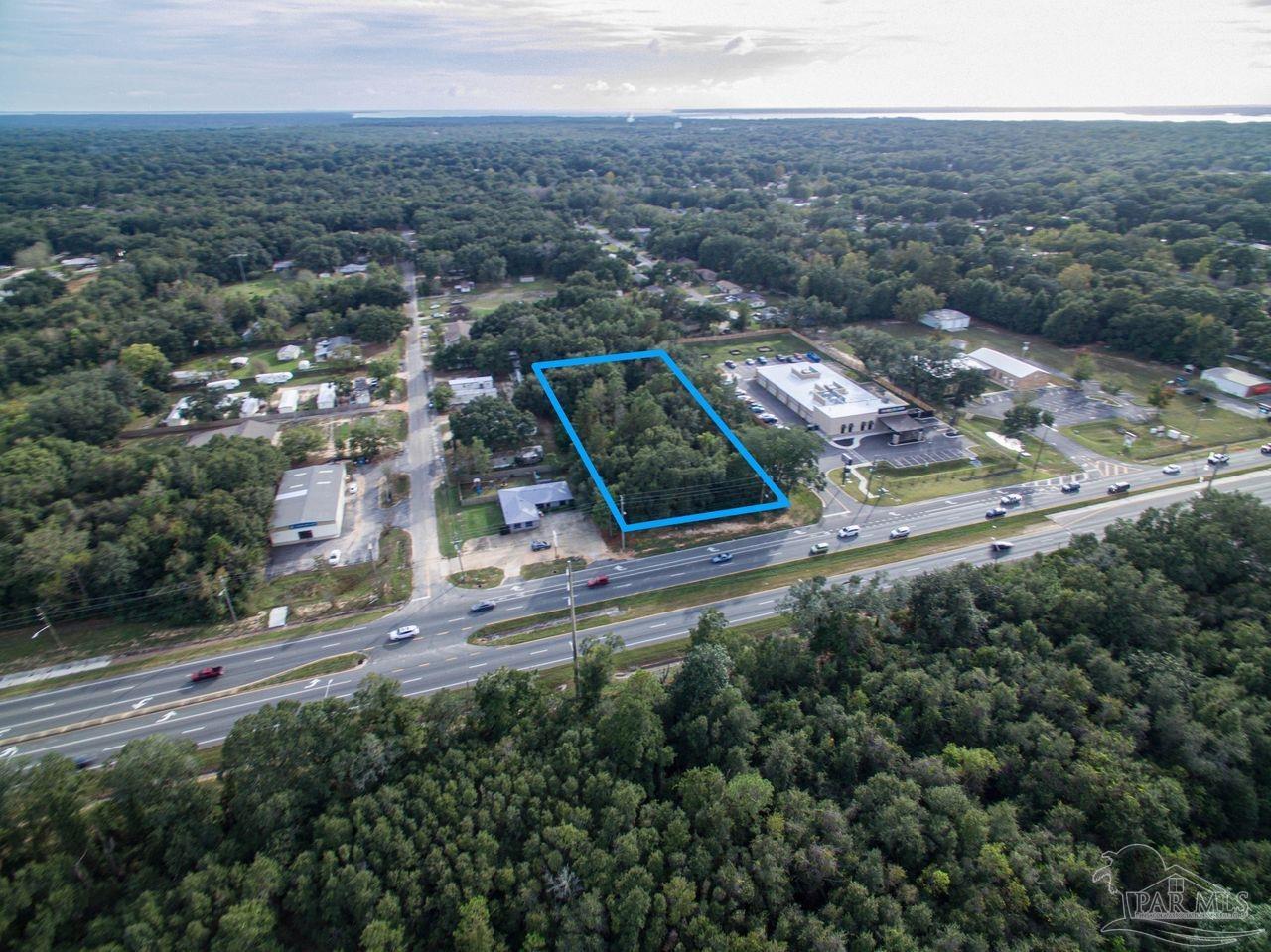 5321 Highway 90 Pace, FL 32571 - Photo 7 of 7 an aerial view of residential houses with outdoor space and trees