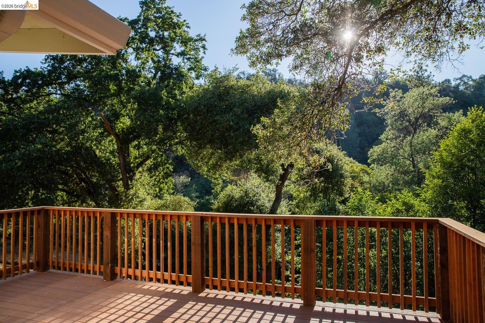 18399 Lime Kiln Road Sonora, CA 95370 - Photo 24 of 36 Expansive outdoor decking with wood railings and balusters