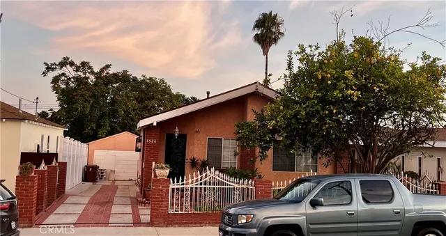 a view of a car park in front of a house
