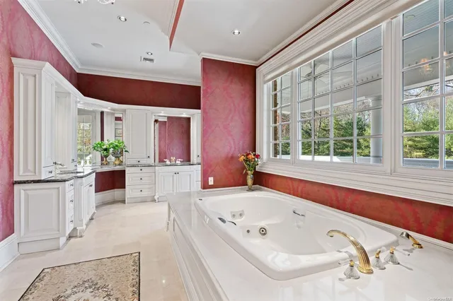 a bathroom with a bathtub a sink and a large mirror